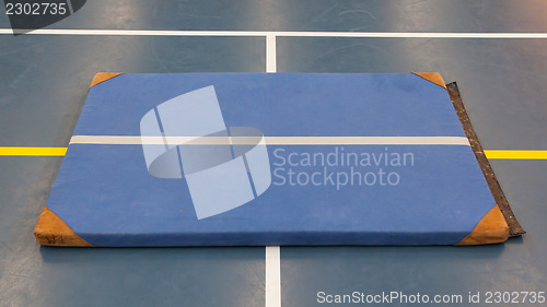 Image of Very old blue mat on a blue court