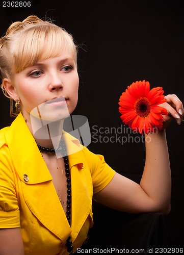 Image of beautiful female holding red flower
