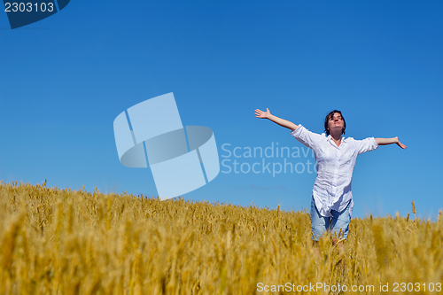 Image of young woman with spreading arms to sky