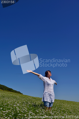 Image of young woman with spreading arms to sky