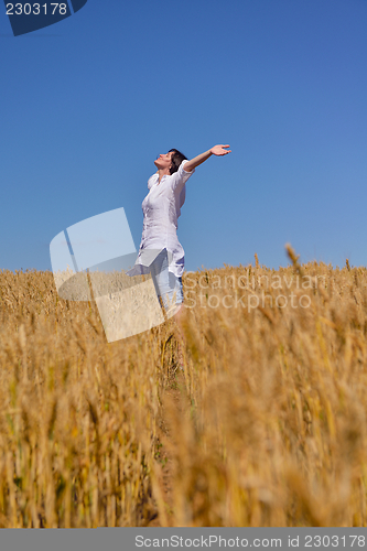 Image of young woman with spreading arms to sky