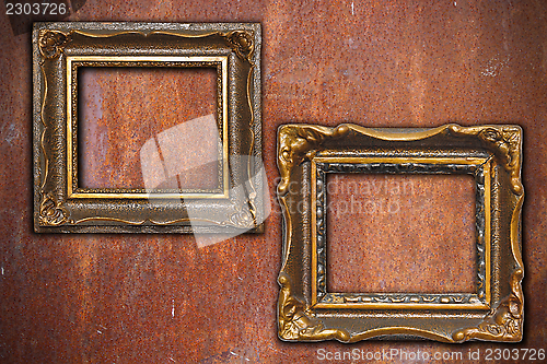 Image of two vintage frames on rusty metal wall
