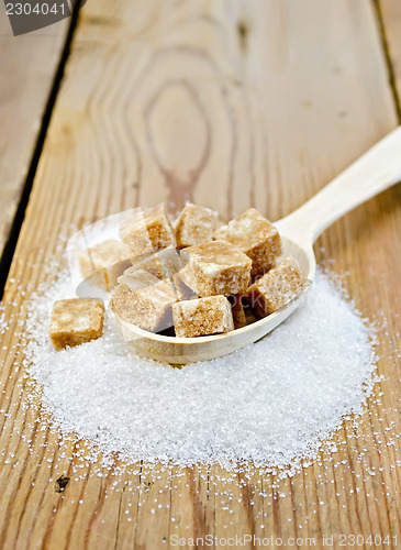 Image of Sugar brown and granulated sugar in a spoon on the board