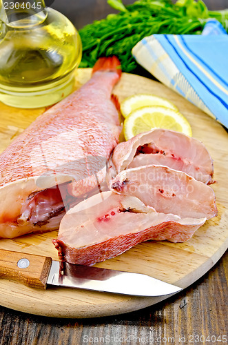 Image of Fillet of sea bass with oil on board