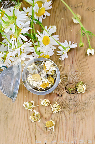 Image of Herbal tea from chamomile dry in a strainer