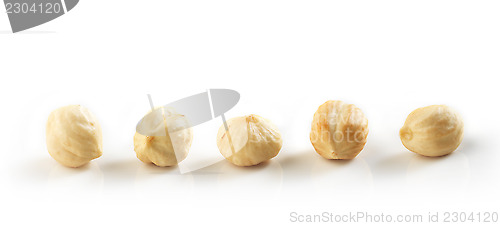 Image of Closeup view of hazelnuts over white background