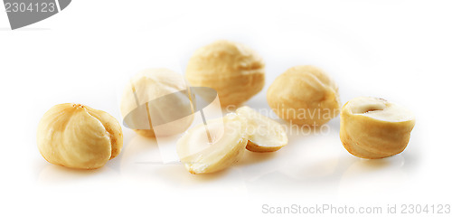 Image of Closeup view of hazelnuts over white background