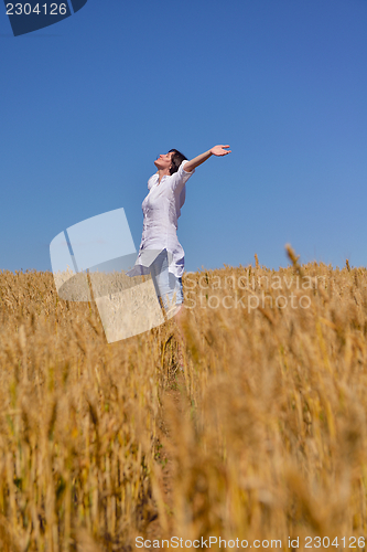 Image of young woman with spreading arms to sky
