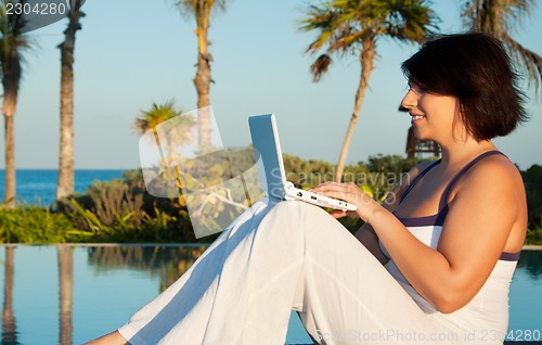 Image of lovely woman with laptop computer