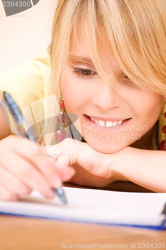 Image of teenage girl with notebook and pen