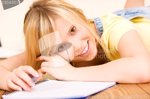 Image of teenage girl with notebook and pen