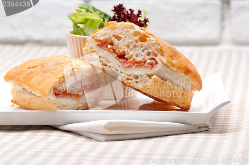 Image of ciabatta panini sandwich with parma ham and tomato