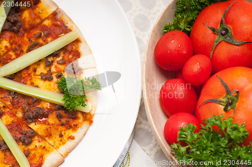 Image of Turkish beef pizza with cucumber on top