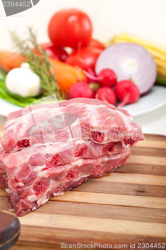 Image of chopping fresh pork ribs and vegetables