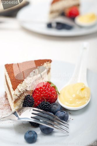 Image of tiramisu dessert with berries and cream