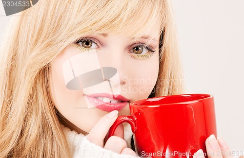 Image of happy teenage girl with red mug