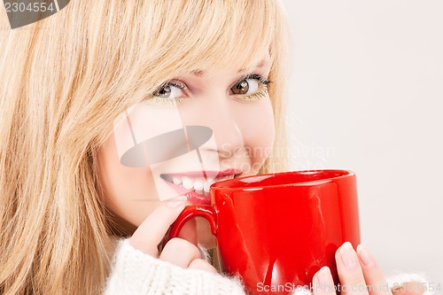 Image of happy teenage girl with red mug