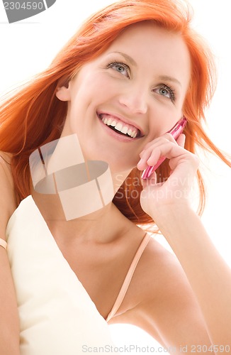 Image of happy redhead woman with cell phone