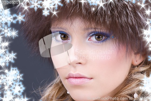 Image of lovely woman in furry hat over grey