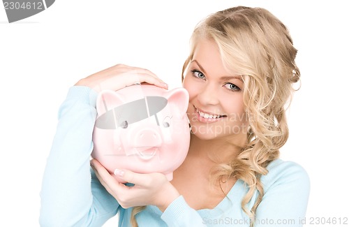 Image of lovely woman with piggy bank