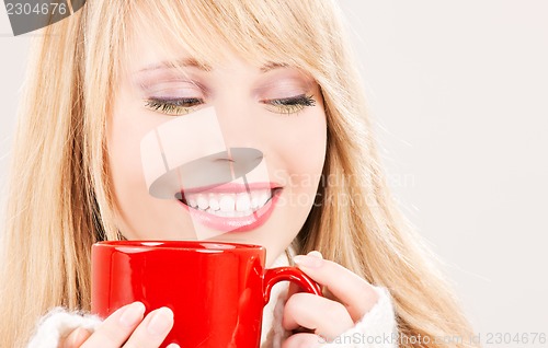 Image of happy teenage girl with red mug