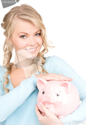 Image of lovely woman with piggy bank