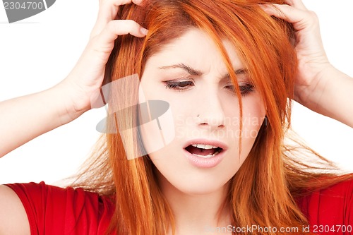 Image of unhappy redhead woman