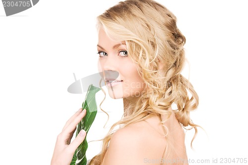 Image of woman with green leaf