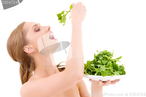 Image of happy woman with spinach