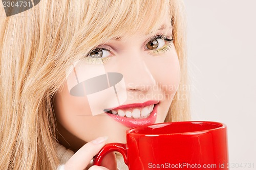 Image of happy teenage girl with red mug