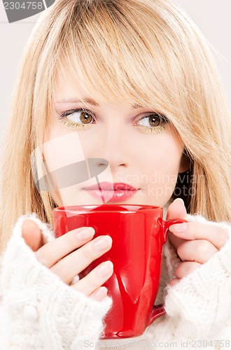 Image of lovely teenage girl with red mug