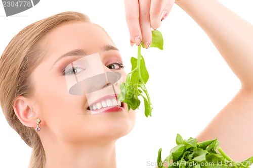 Image of happy woman with spinach