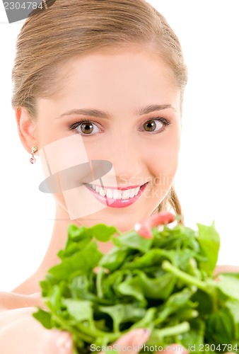 Image of happy woman with spinach