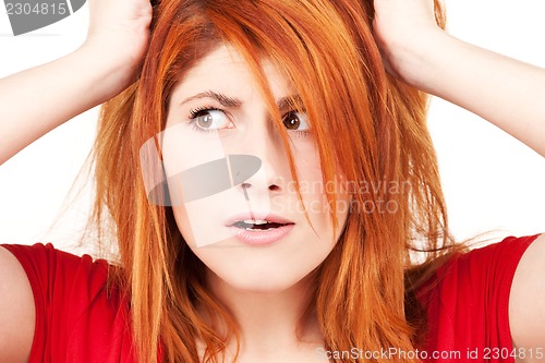 Image of unhappy redhead woman