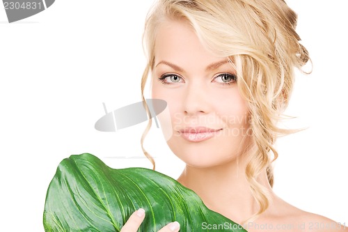 Image of woman with green leaf