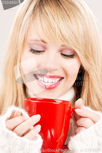 Image of happy teenage girl with red mug