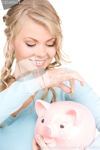 Image of lovely woman with piggy bank