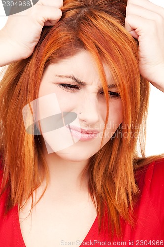 Image of unhappy redhead woman