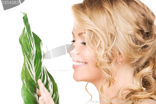 Image of woman with green leaf