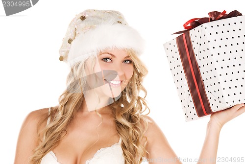 Image of cheerful santa helper girl with gift box