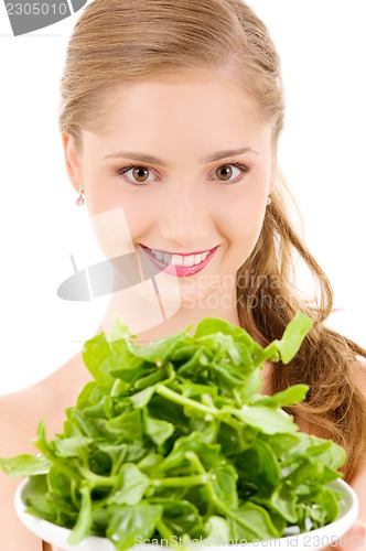 Image of happy woman with spinach