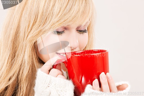 Image of happy teenage girl with red mug