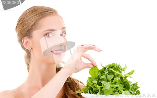 Image of happy woman with spinach