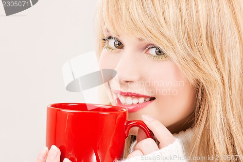 Image of happy teenage girl with red mug