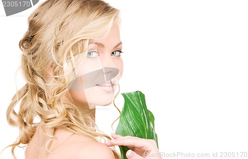 Image of woman with green leaf