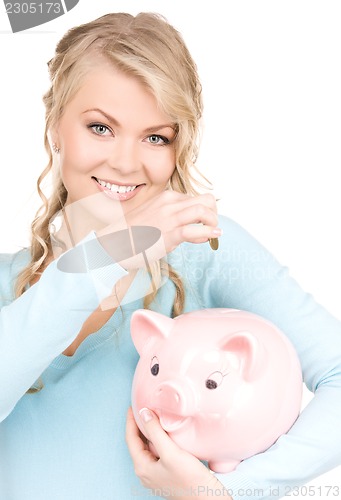 Image of lovely woman with piggy bank