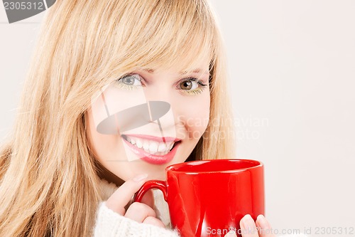 Image of happy teenage girl with red mug