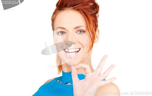 Image of lovely redhead showing ok sign