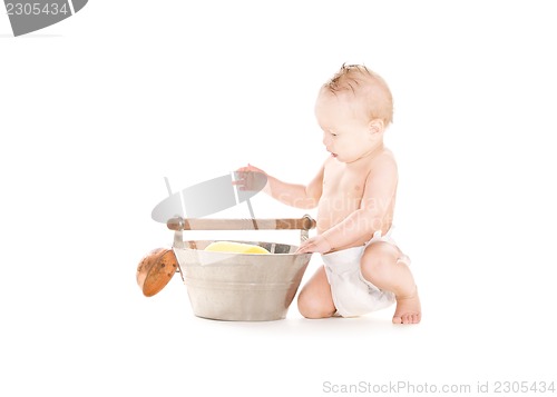 Image of baby boy with wash-tub and scoop