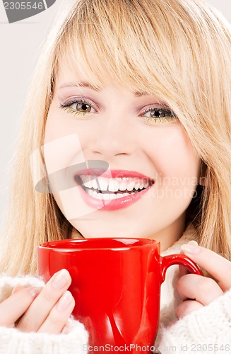 Image of happy teenage girl with red mug